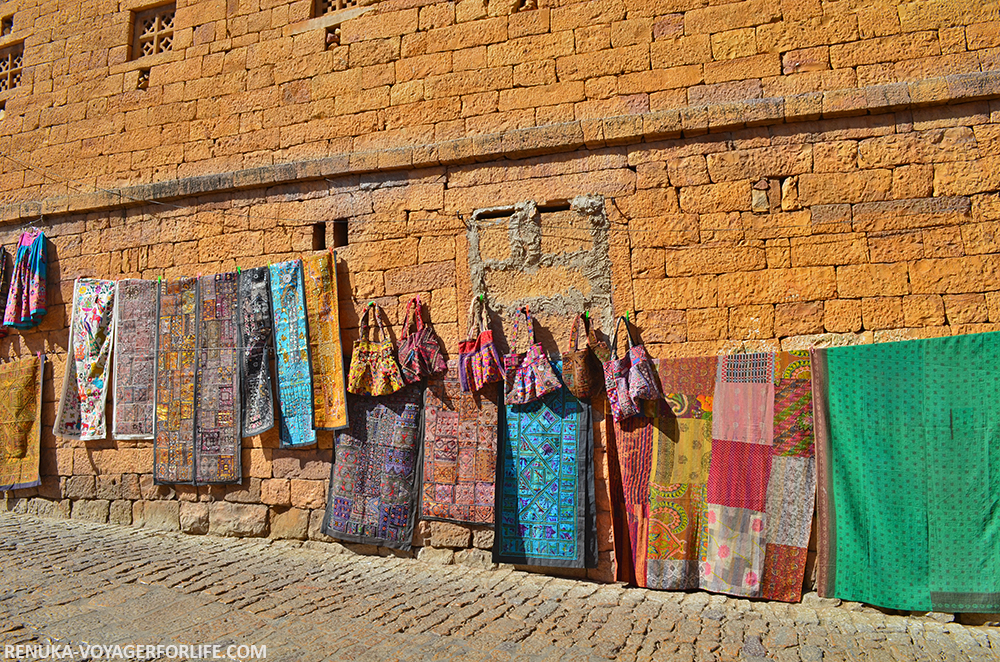 IMG-Golden walls and colorful shops at Jaisalmer Fort.